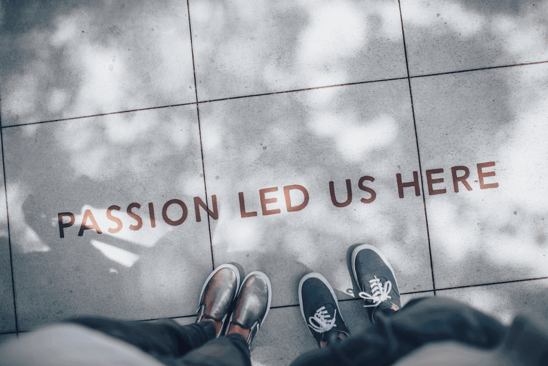 a person's feet on a tile floor with words on it
