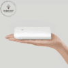a hand holding a white rectangular object